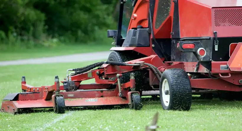 Commercial wide-area mower cutting a large property
